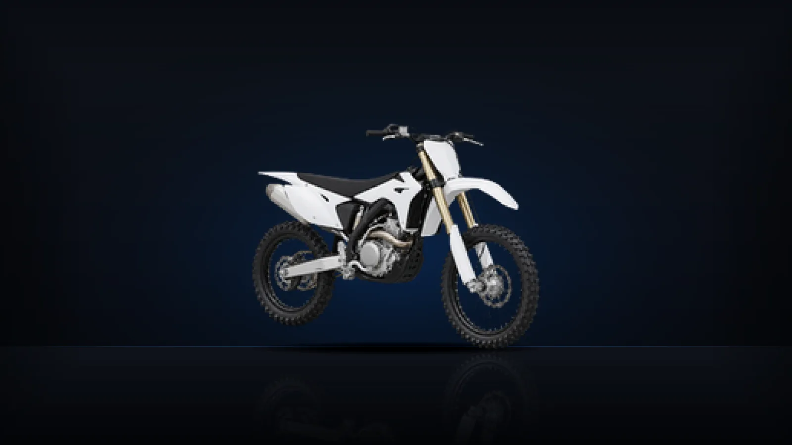 A white off-road motorcycle standing on a dark studio floor