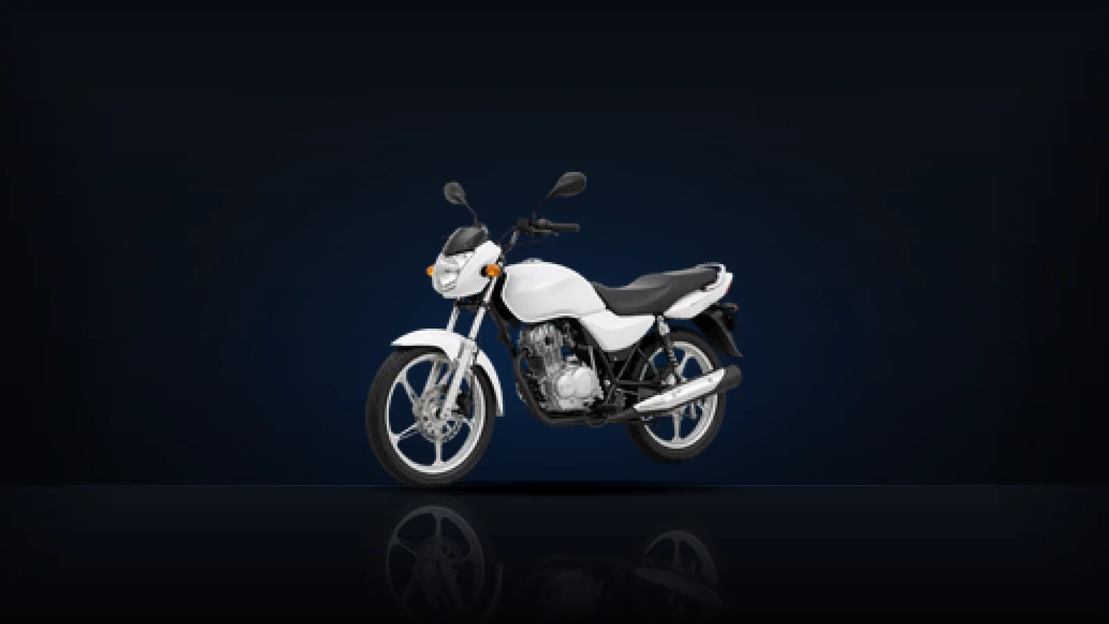 A white commuter motorcycle, the kind most new riders learn on, on a dark floor