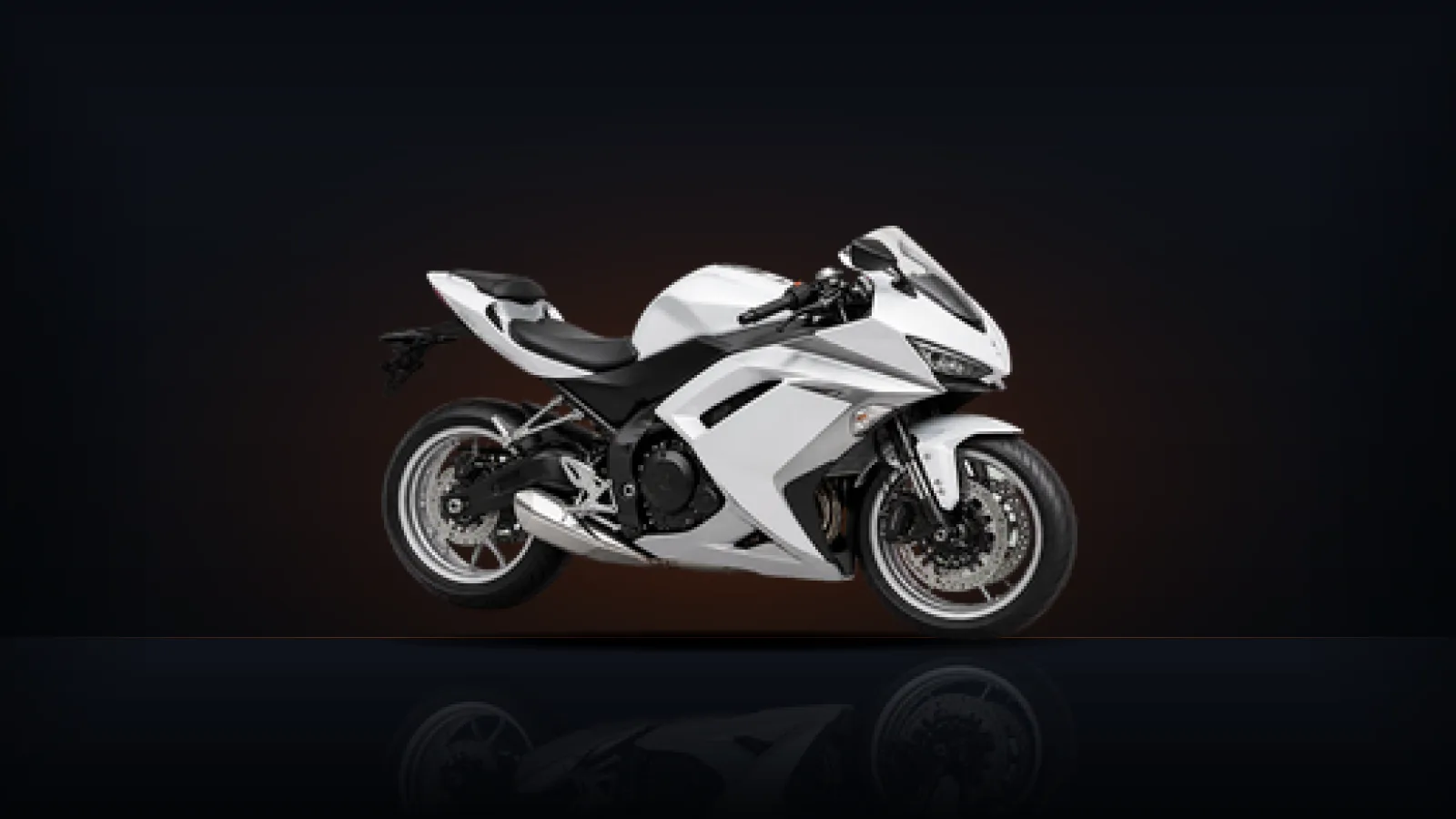 A clean white sport motorcycle photographed side-on against a dark background
